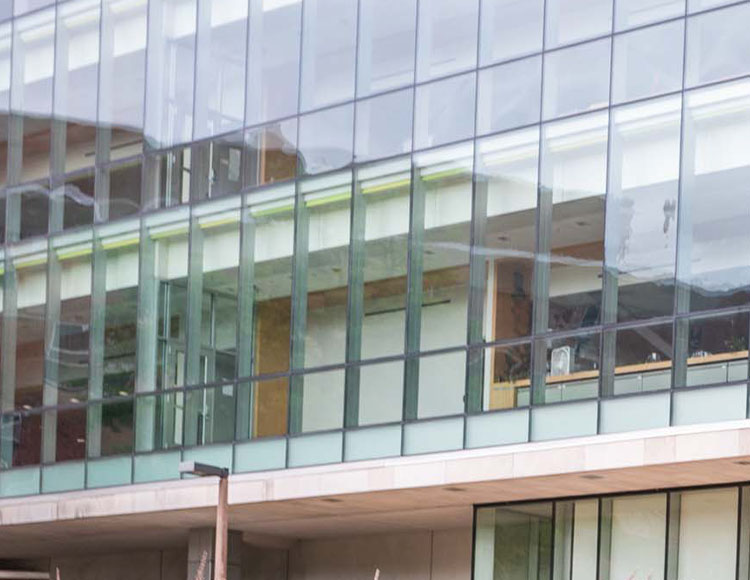 The outside of a building that shows three stories of windows.