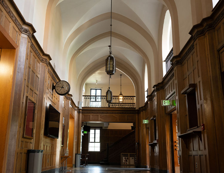 Three pendant lights hanging from a vaulted ceiling in the entryway to Fairchild Theatre.