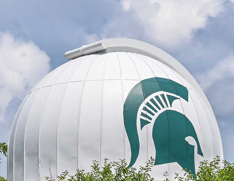 A white dome set against a blue sky. The dome has a Spartan helmet.