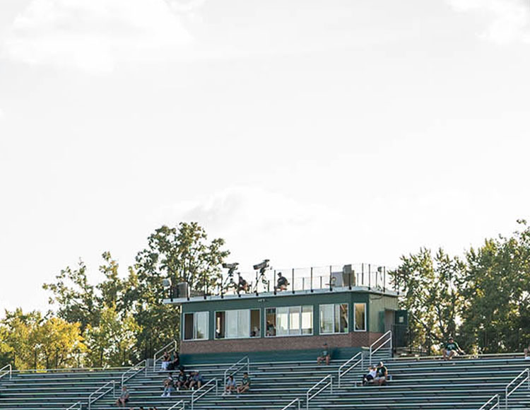 Trees, bleachers and a press box.