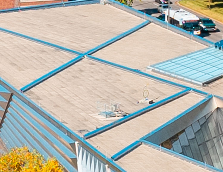 Gray shapes of a roof, taken from above.