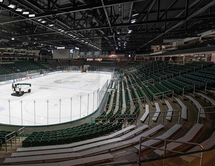Rows of green seats and silver benches.
